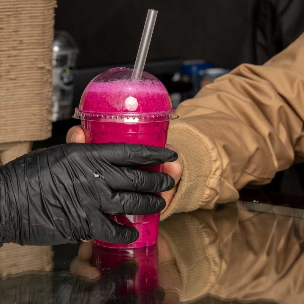 Pink fresh juice in a clear Juices4Life cup