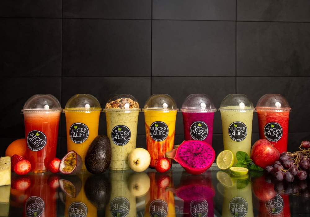 Row of fresh Juices4Life juices and smoothies with whole fruit