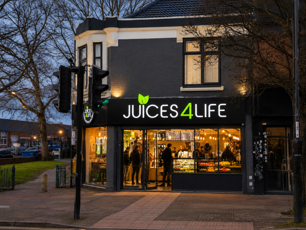 Juices4Life juice bar shopfront lit up in the evening